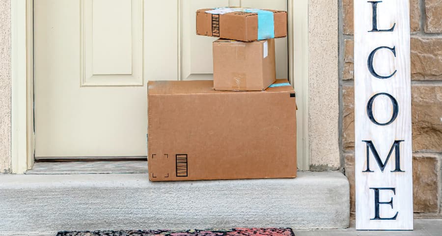 Boxes by the door of a residence with a welcome sign in Bakersfield